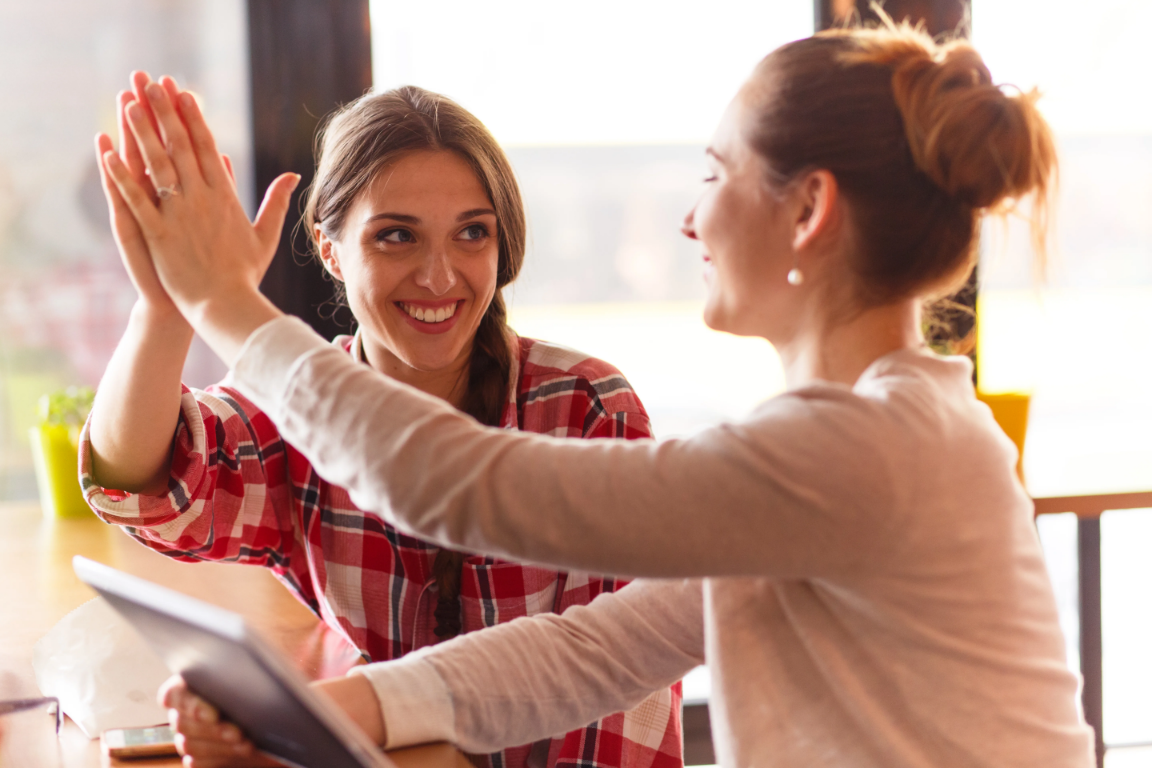 Two women high-fiving