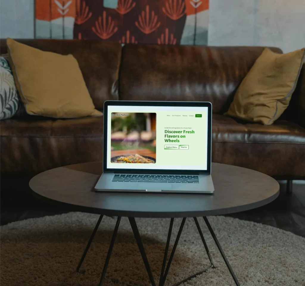 Garden Parkin homepage being displayed on a laptop, sitting on a coffee table with a couch in background.